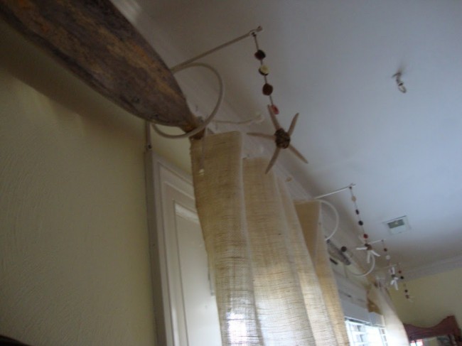 oars as curtain rods with burlap curtains
